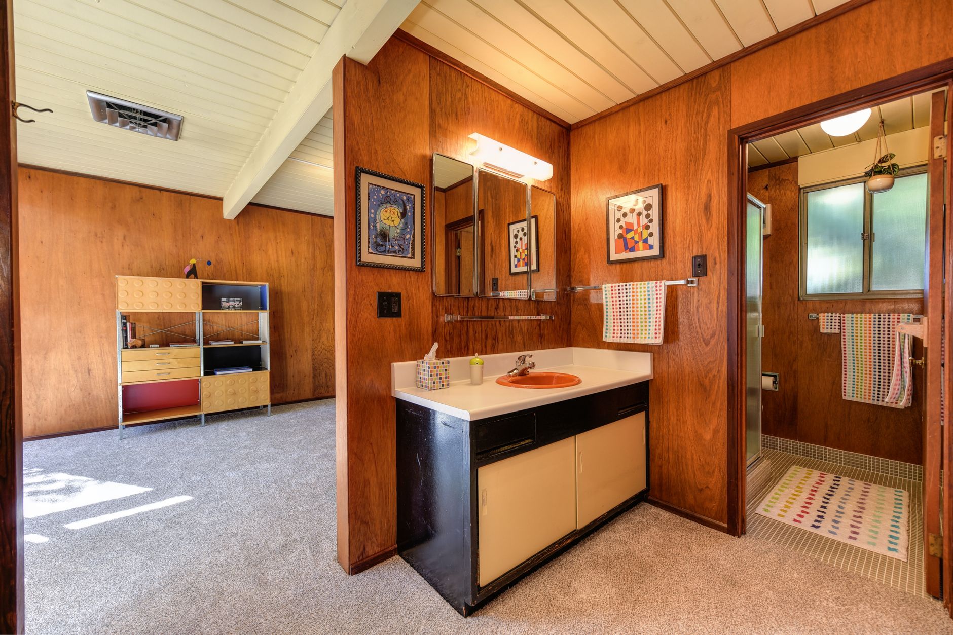 Wood-paneled bath with beamed T&G ceiling and period cabinetry