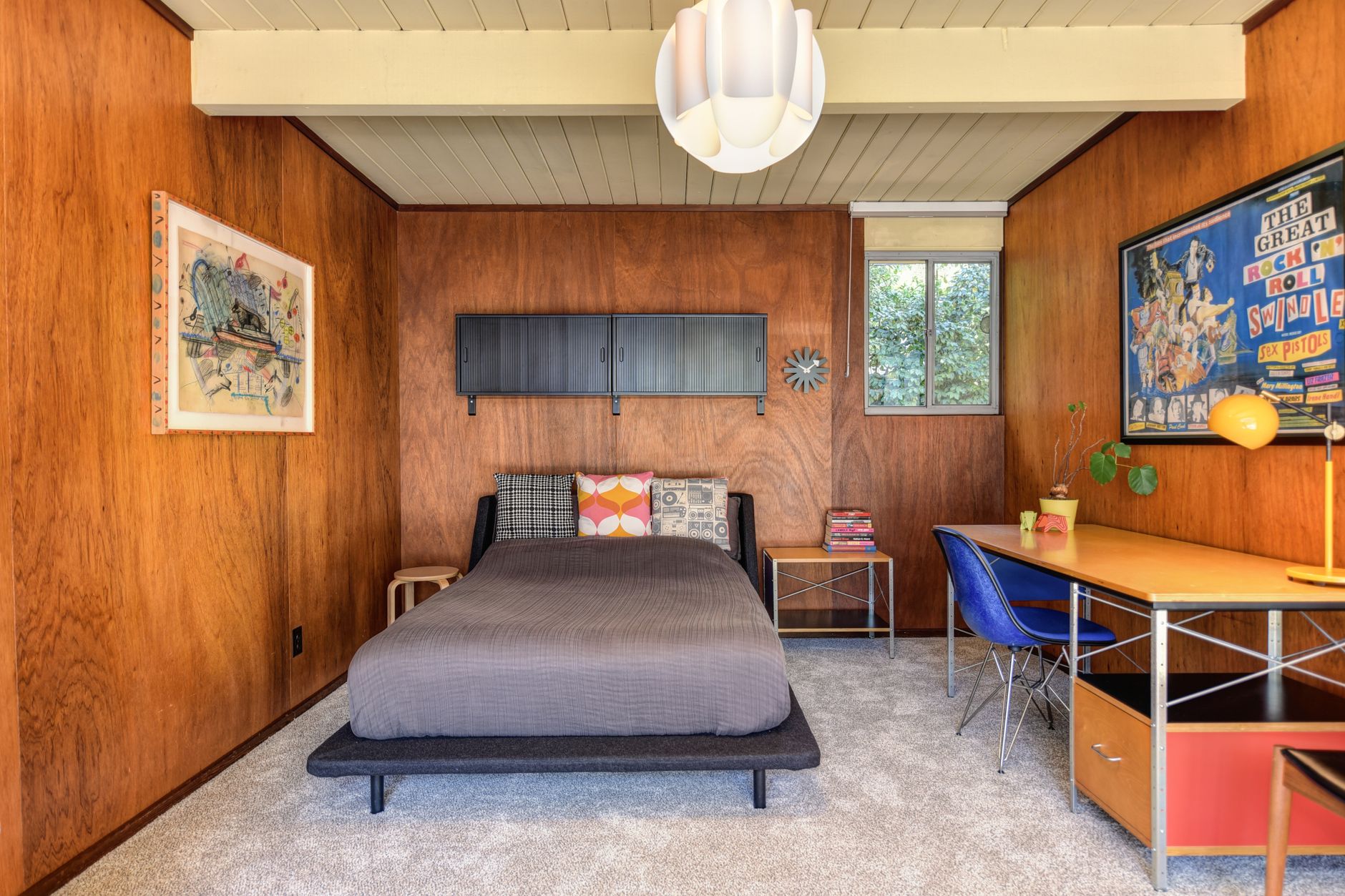 Mahogany-paneled bedroom with beamed ceiling and MCM furnishings