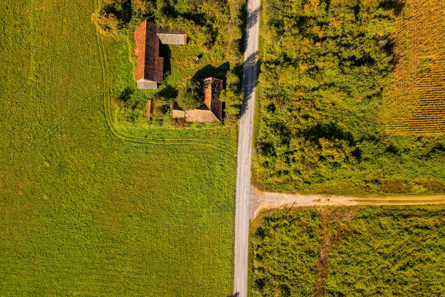 Aerial shot of a rural farmhouse surrounded by fields in Garešnica, Croatia.